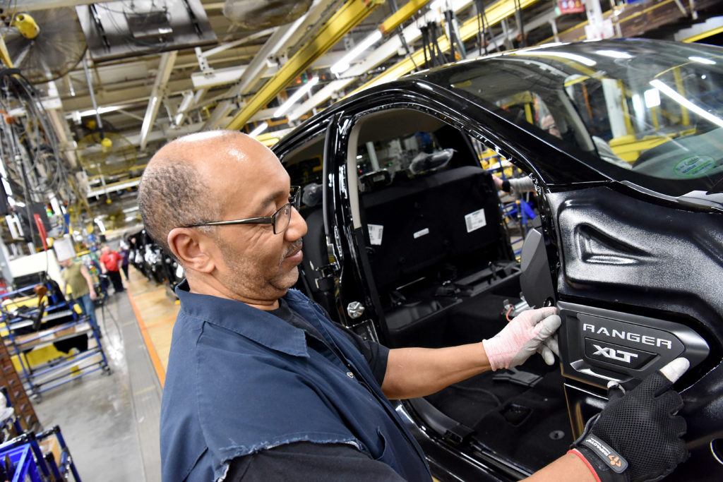 Duane Moore, Ford Motor Company employee, applies a badge to a 2019 Ranger at Michigan Assembly. Ford has temporary closed the facility after an employee tested positive for Coronavirus.  