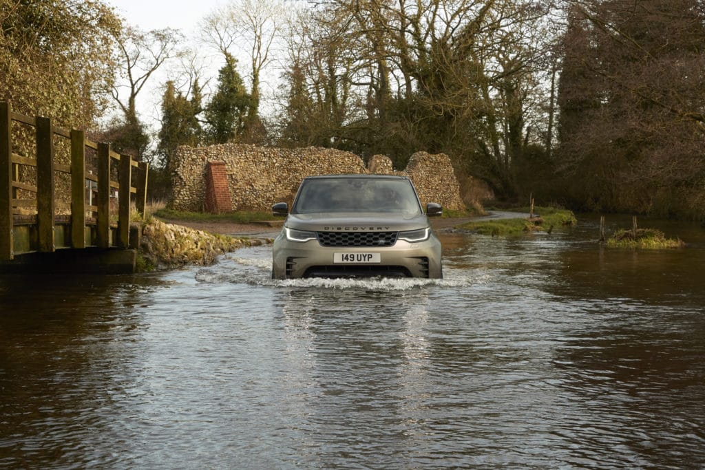 2021 Land Rover Discovery fording water.